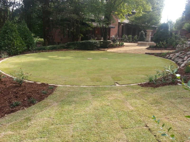 Lawn landscaping by John Russell Landscape Architect with a circular design and lush greenery.