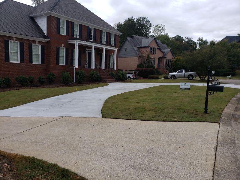 Concrete driveway and walkway design by John Russell Landscape Architect. Expertly crafted for curb appeal and durability in residential landscape projects.