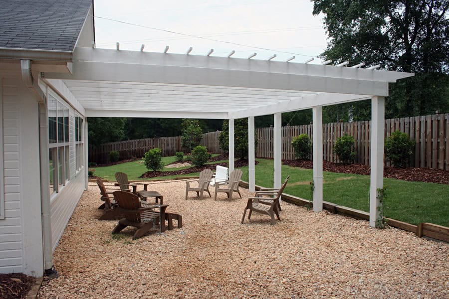 Privacy-garden-patio-design-with-adirondack-chairs-and-pergola-in-backyard.