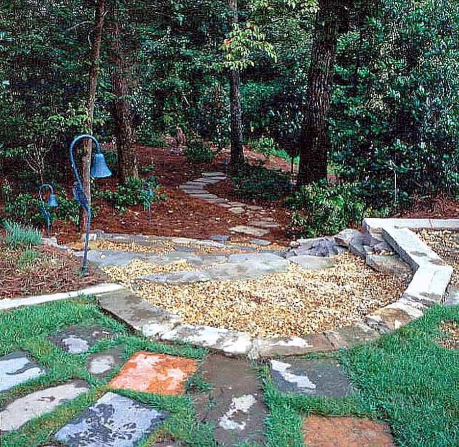 Natural woodland garden with stone pathways and outdoor lighting, designed by John Russell Landscape Architect for harmonious outdoor living.