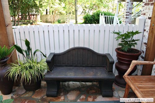 Elegant outdoor patio with customized seating and lush potted plants designed by John Russell Landscape Architect.