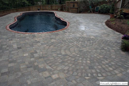 Natural stone paver pool deck design by John Russell Landscape Architect showcasing durable outdoor living solutions.