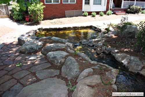 Natural stone pathway and pond design by John Russell Landscape Architect, enhancing outdoor spaces with landscaping, water features, and landscape architecture expertise.