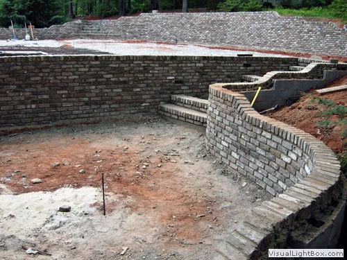 Natural stone retaining wall construction by John Russell Landscape Architect showcasing landscape hardscaping and outdoor design expertise in Connecticut.
