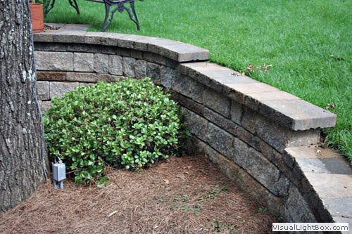 Stone retaining wall landscape design by John Russell Landscape Architect showcasing durable outdoor hardscape solutions.