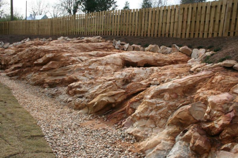 Rock landscaping and erosion control by John Russell Landscape Architect featuring natural stone design.