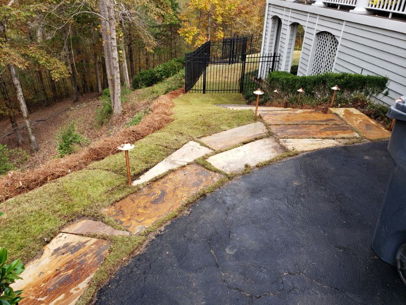 Natural stone walkway and landscaped yard design by John Russell Landscape Architect in a suburban outdoor space.