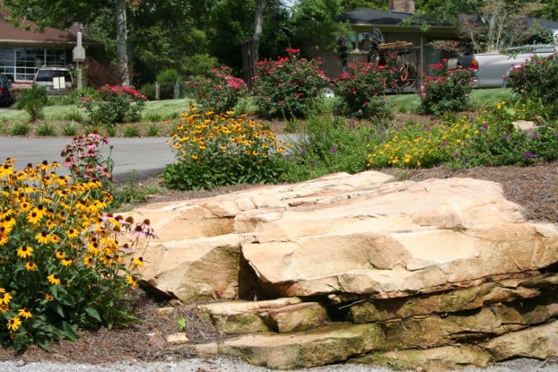 Rock garden landscape design with flowering plants and stone accents, professional landscape architecture services by John Russell Landscape Architect.