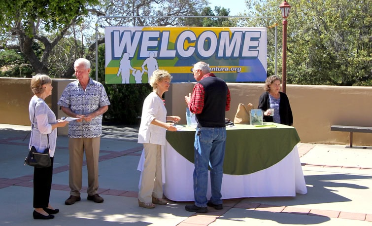 Welcome Center display with full-color outdoor vinyl banner and matching vertical flags by J. Thow Designs