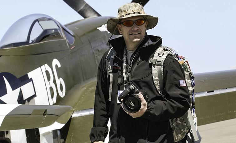 Aviation photographer John Thow standing in front of P-51D Mustang Speedball Alice at Madera Airport