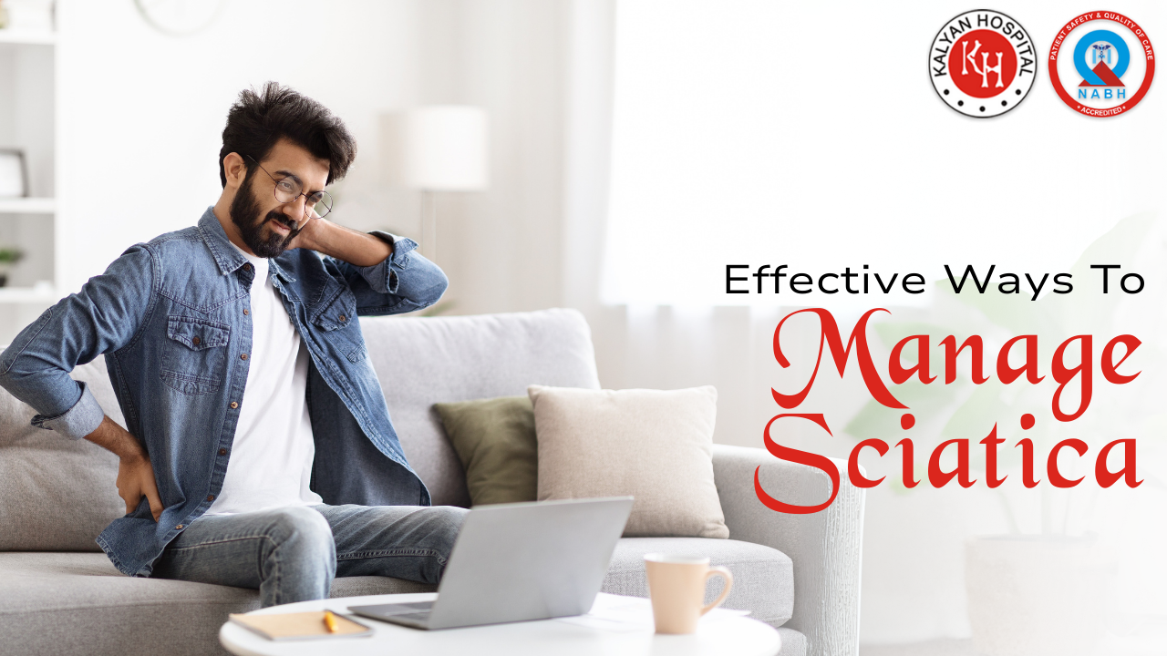 a man sitting on a sofa with laptop, holding his lower back and neck in pain