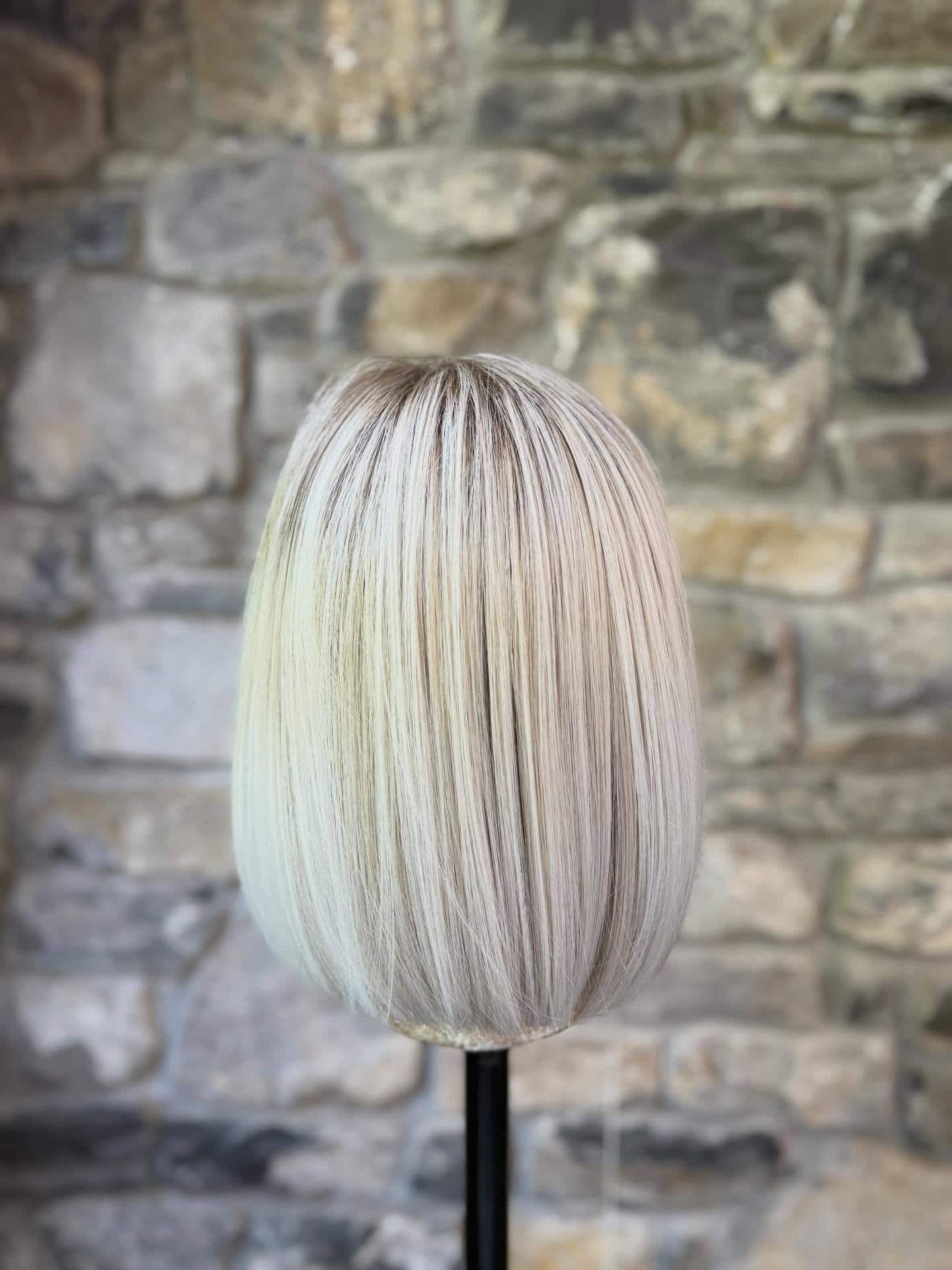 Blonde bob hairstyle showcasing hair enhancers for volume and shine.