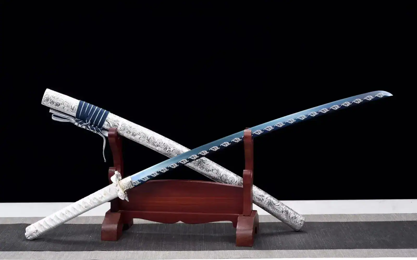 Crossed katana display on wooden stand