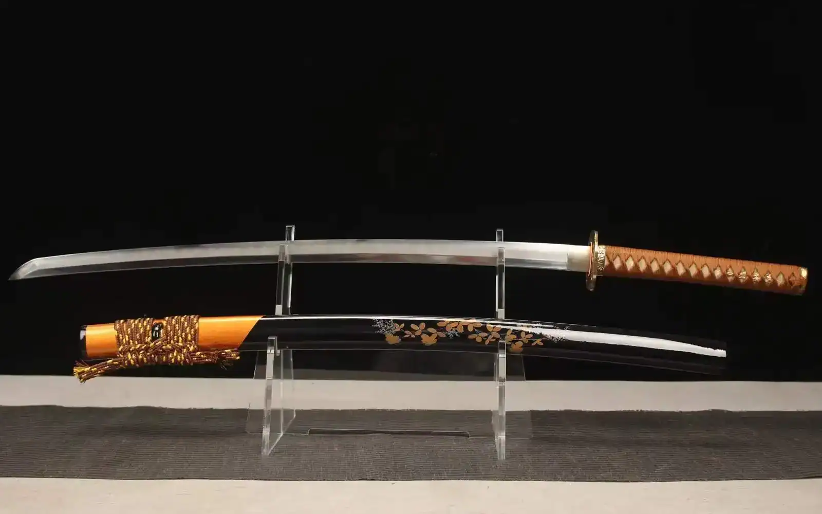 Katana with silver blade, brown handle, and black scabbard