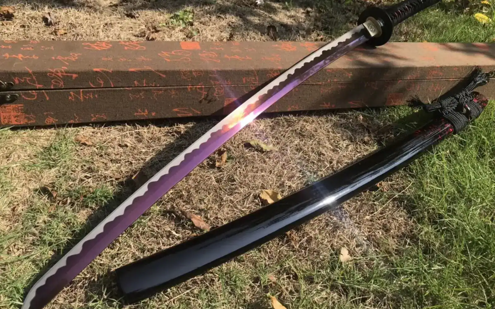 katana sword displayed outdoors on grass