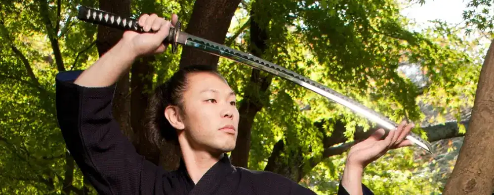 Samurai holding curved katana sword
