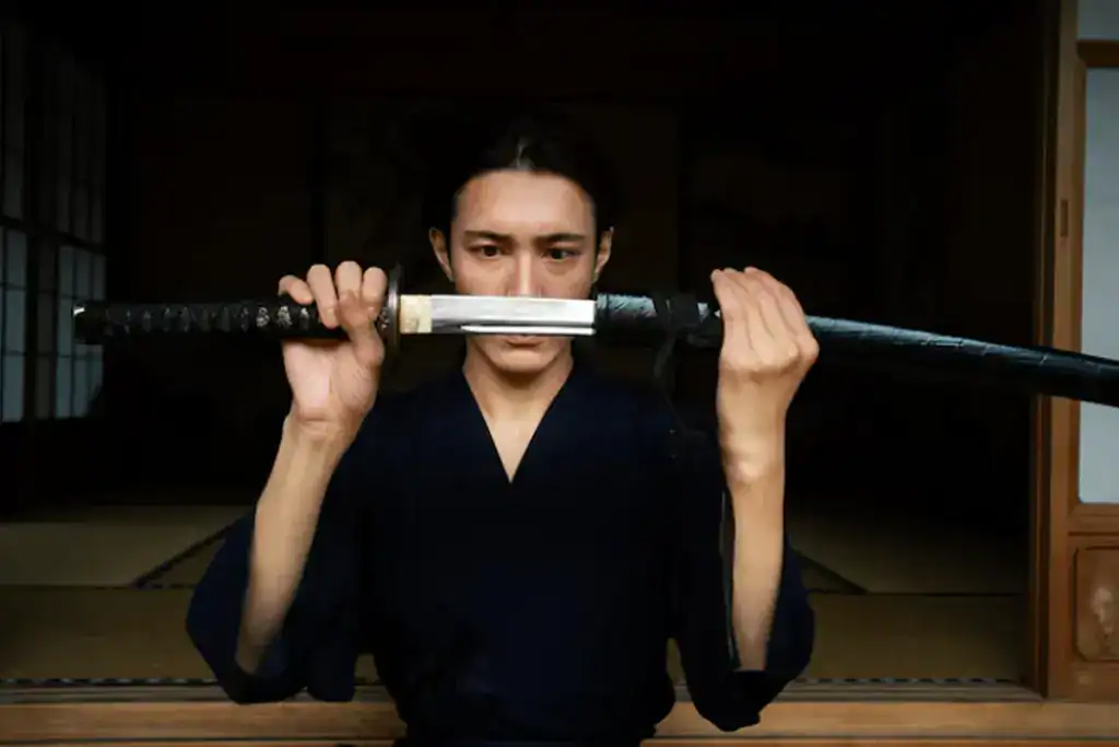 Person inspecting a katana blade