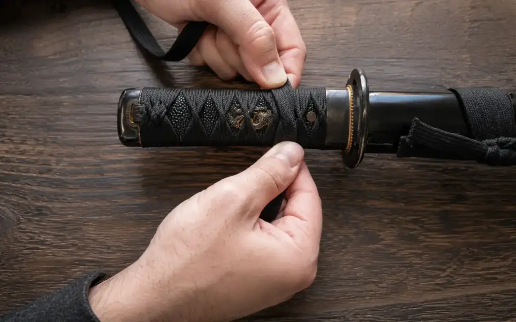 hands wrapping a katana handle