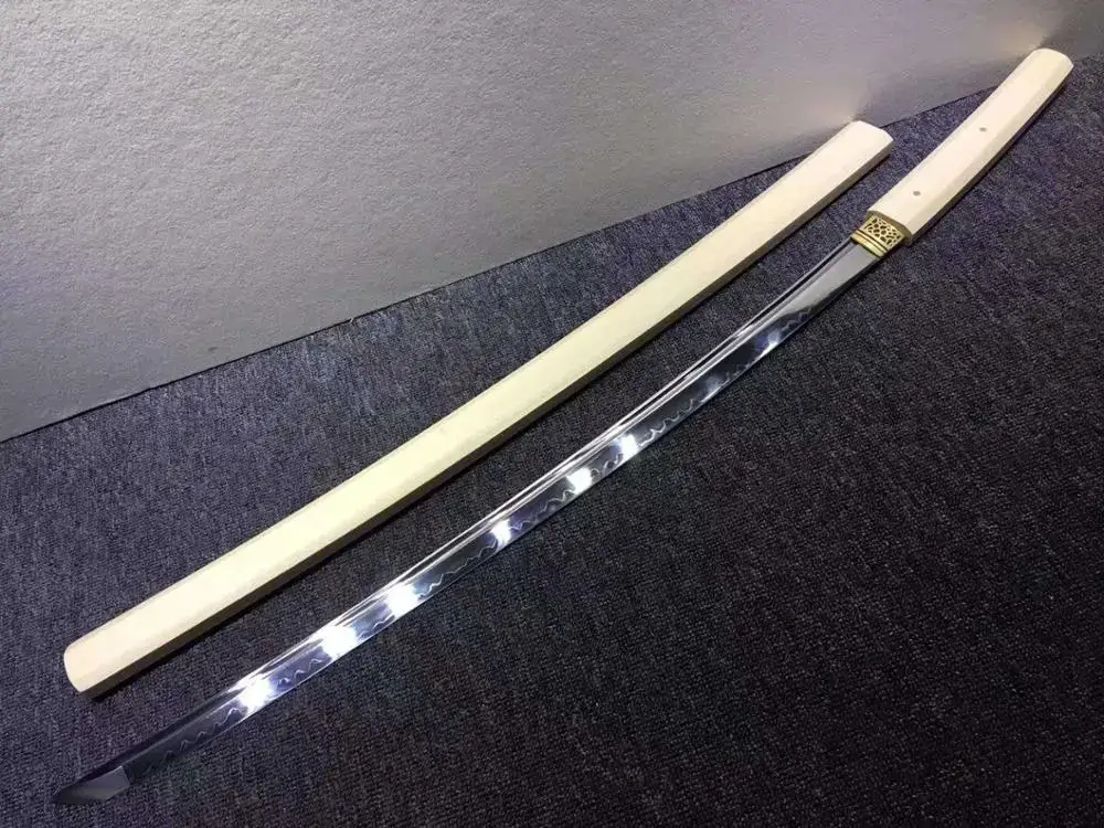 Plain wooden shirasaya beside polished blade