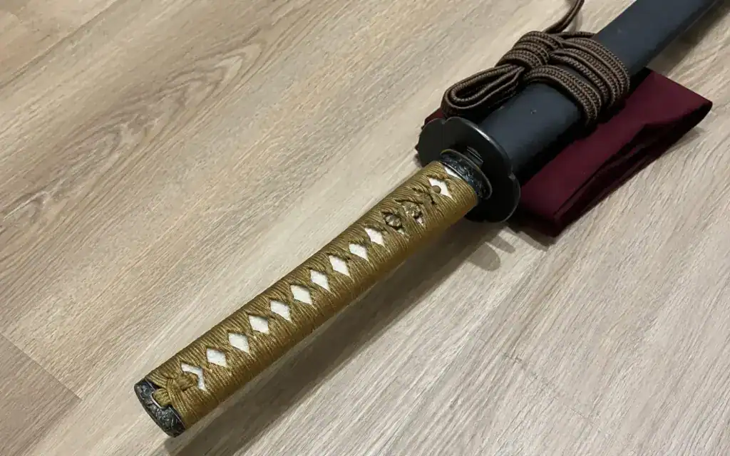 Wrapped tsuka and tsuba on koshirae