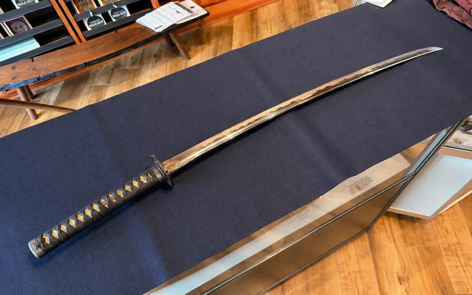Katana displayed with scabbard on table