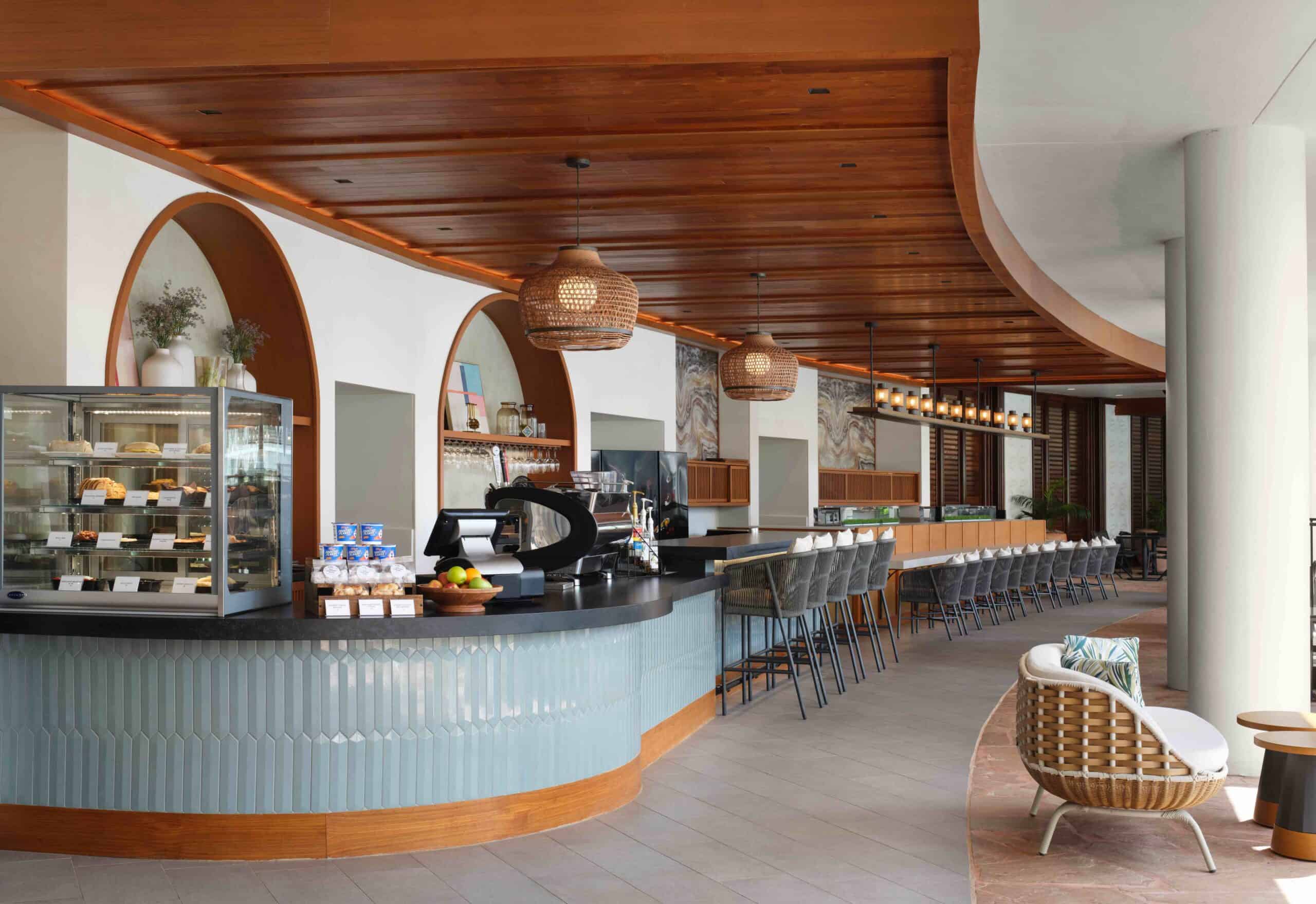 Outdoor dining area at the beach club, featuring tables and chairs with ocean views.