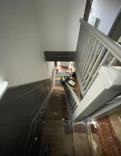 Interior staircase with fresh paint and polished wooden steps, showcasing professional decorating se.
