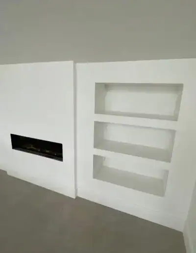 Built-in white wall shelves with a sleek fireplace for modern home decor.