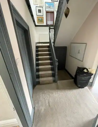 Stylish staircase with gallery wall and decor in a home interior.