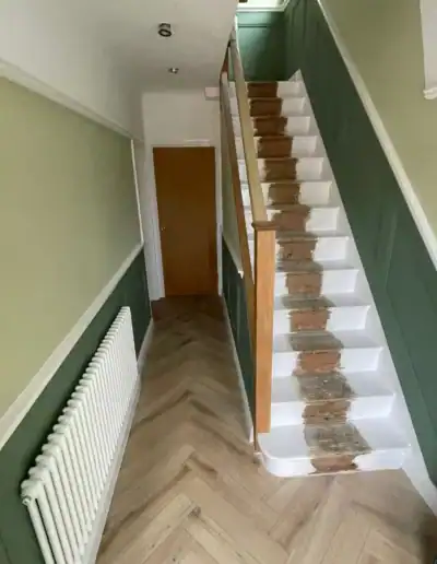 Renovating staircase with fresh paint and sanding to improve appearance and safety.