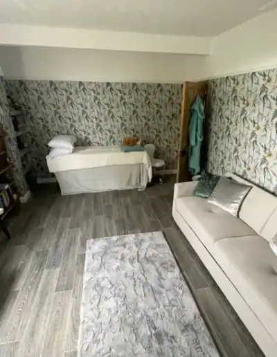 Stylish living room featuring floral wallpaper, modern sofa, and decorative cushions.