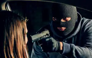 Armed robbery suspect threatening a woman at gunpoint, criminal activity scene, law enforcement and crime investigation, legal defense Attorney Benjamin Arnold.