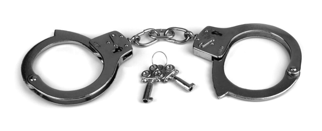 Handcuffs with keys symbolizing legal defense and criminal law services at The Law Office of Benjamin Arnold, experienced criminal defense attorney in Kansas City.