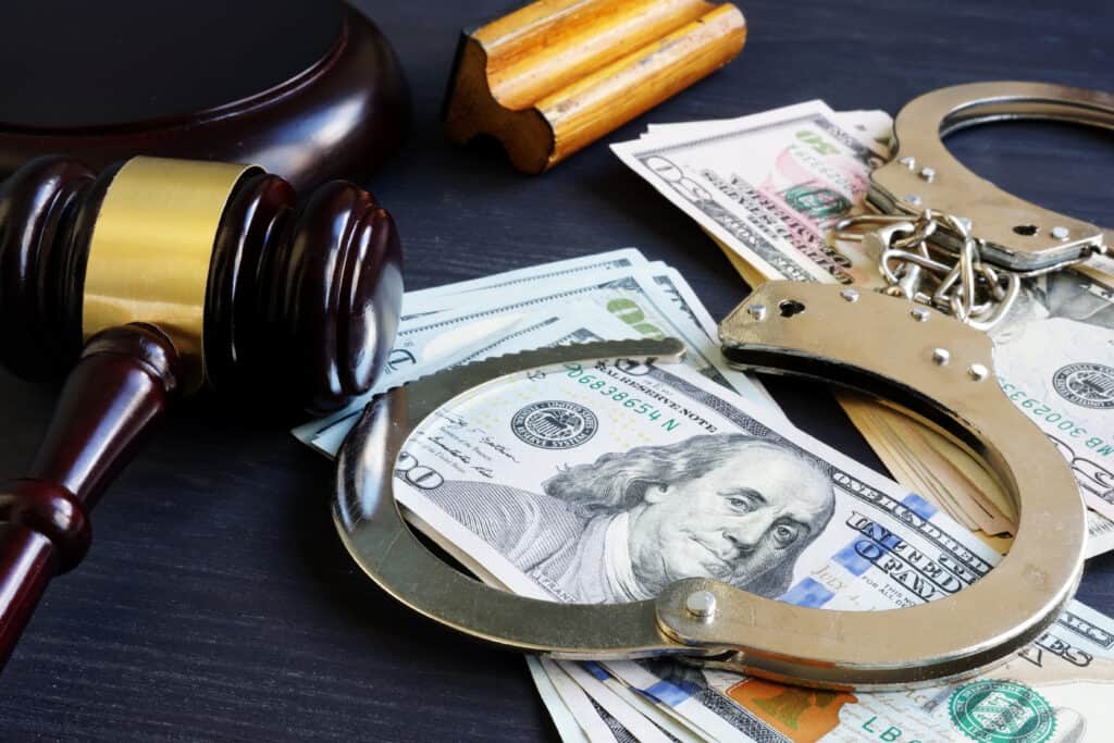 Gavel, handcuffs, money, and legal items representing criminal defense and legal services at The Law Office of Benjamin Arnold.