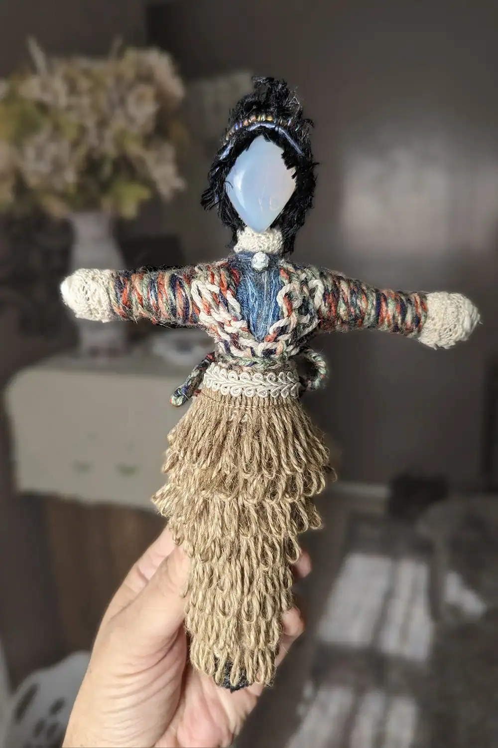 Front view of Roberta, the Moonstone Angels Unawares Art Doll, being held with a calm blurry background