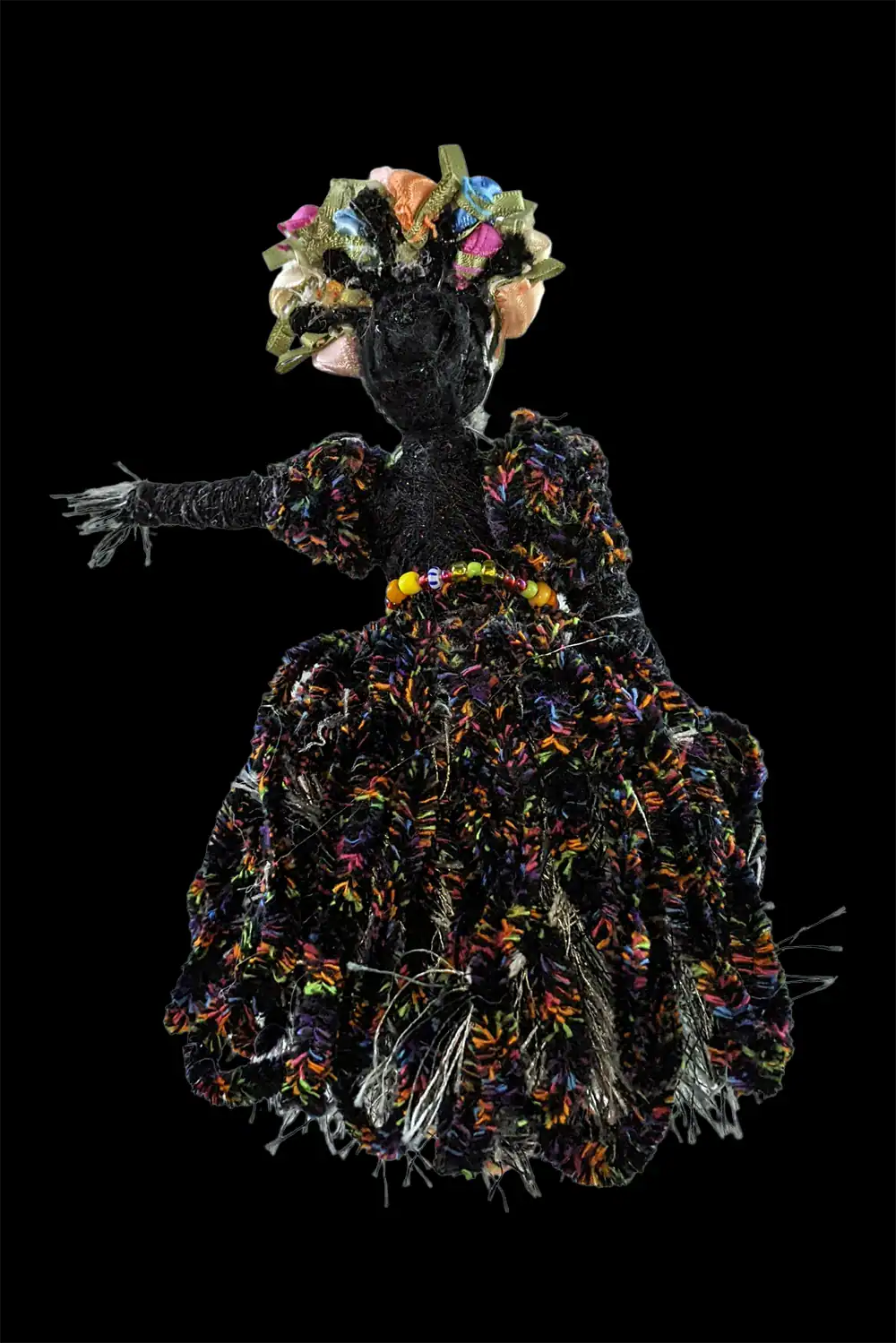 Rear view of one of the Day of the Dead skeleton dolls showcasing her beautiful dress and tight bun hairstyle.