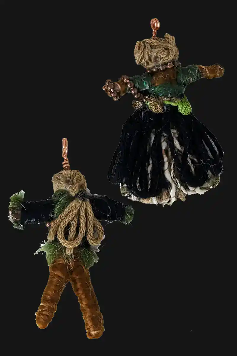 Backsides of the Celtic Couple Pendant Set is dressed in green, brown, black and copper and have wooden beads for their heads. He has a long ponytail and she has princess Leia hair buns.