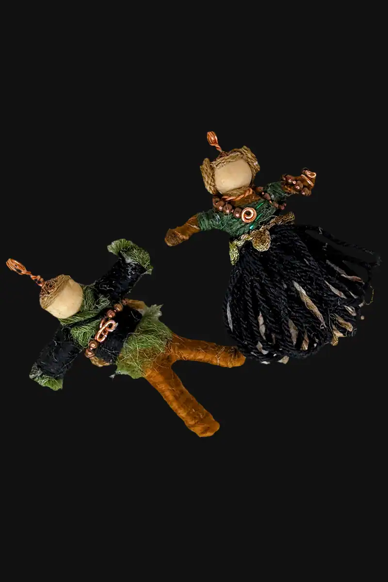Between 2 1/2 and 3 inches tall, the Celtic Couple Pendant Set is dressed in green, brown, black and copper and have wooden beads for their heads.