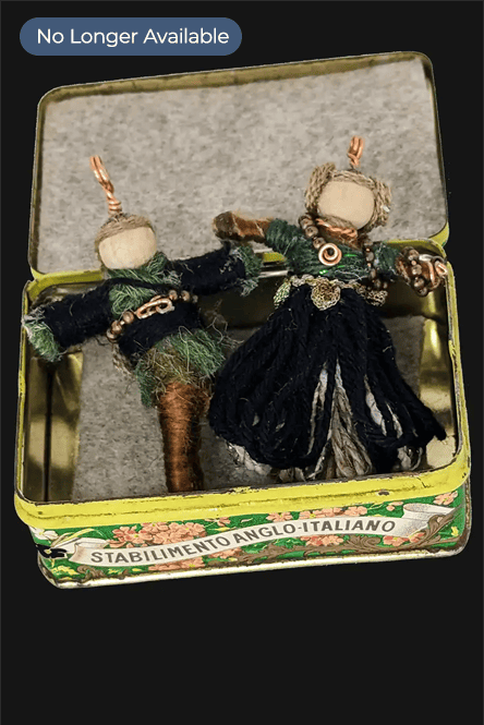 Celtic couple pendants displayed in a decorative tin box.