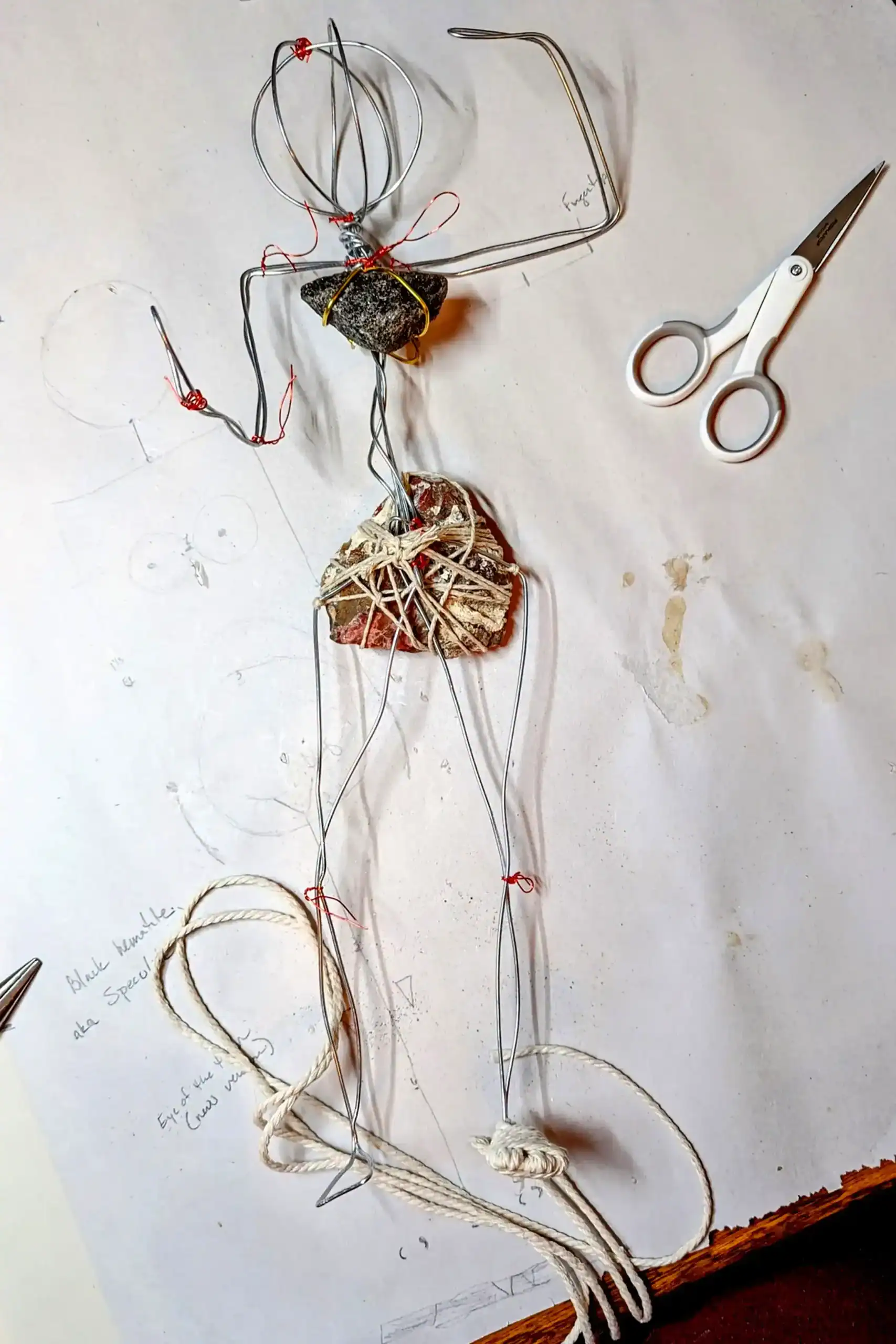 Hannah the Kitchen Witch’s wire armature with gemstones, including jasper and hematite, in the early construction phase.