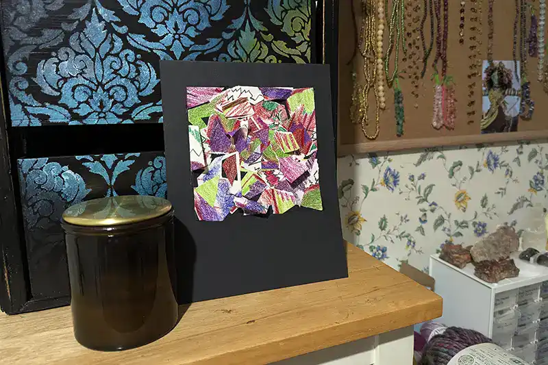 The "tear it apart" art exercise result, displayed in a room as a finished collage artwork.