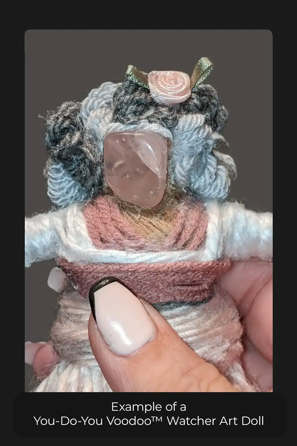 A You-Do-You Voodoo™ Watcher art doll with curly gray and silver hair, held in a woman's hand.
