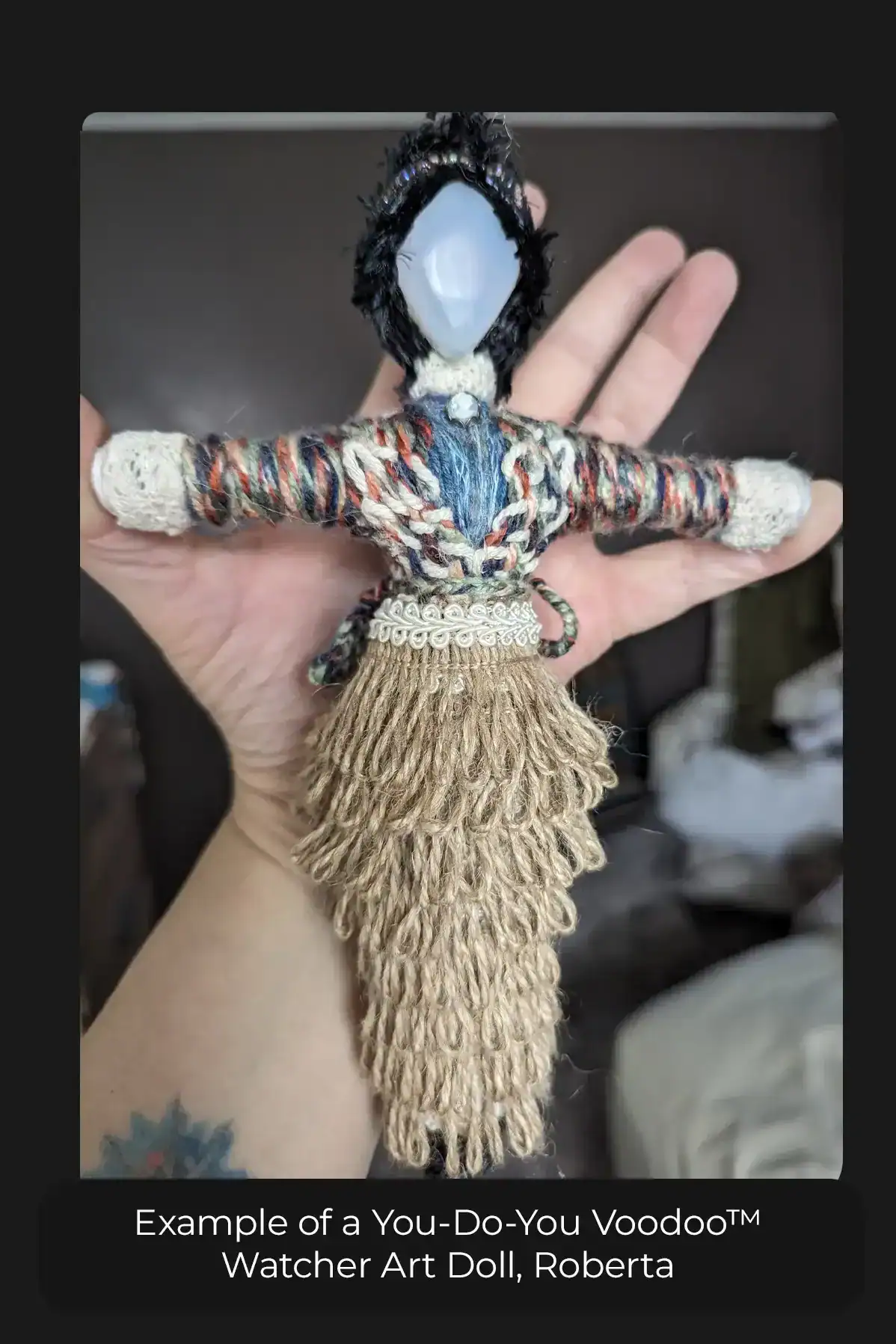 Comparison of a typical Watcher art doll to a woman's hand.