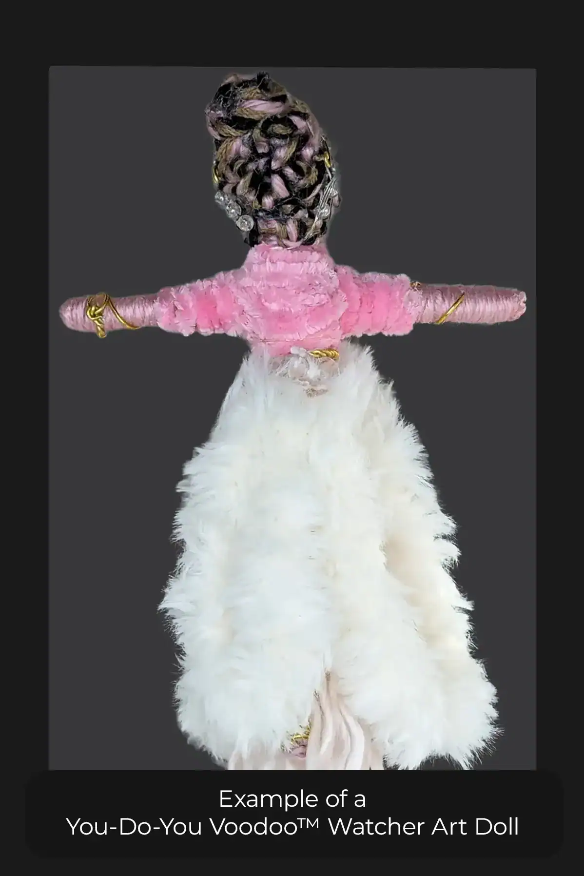 The back view of a You-Do-You Voodoo™ Watcher art doll with black, pink and brown hair braided in an updo.