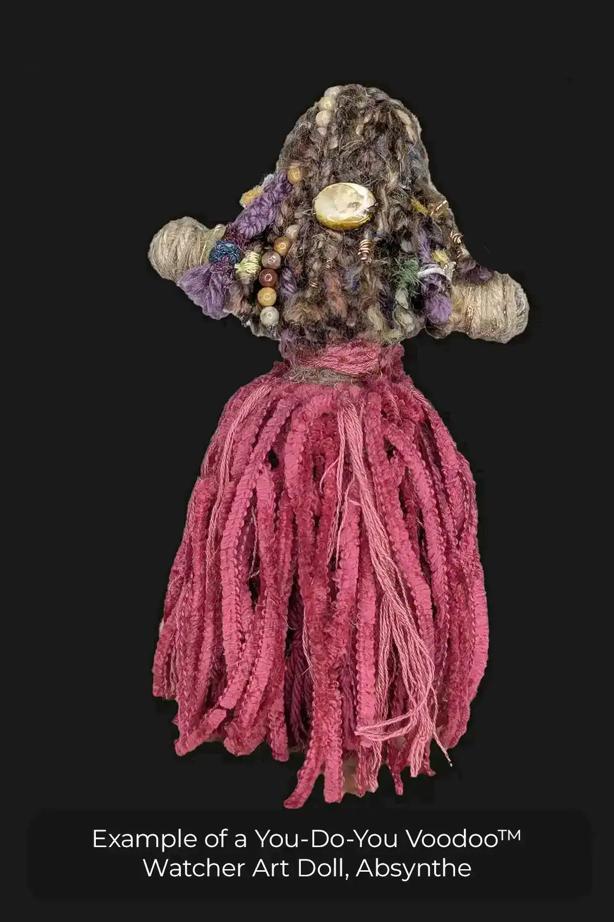 This is the back view of Absynthe the You-Do-You Voodoo™ Watcher doll. You can see the barrettes and copper decorations in her hair and her pink dress.