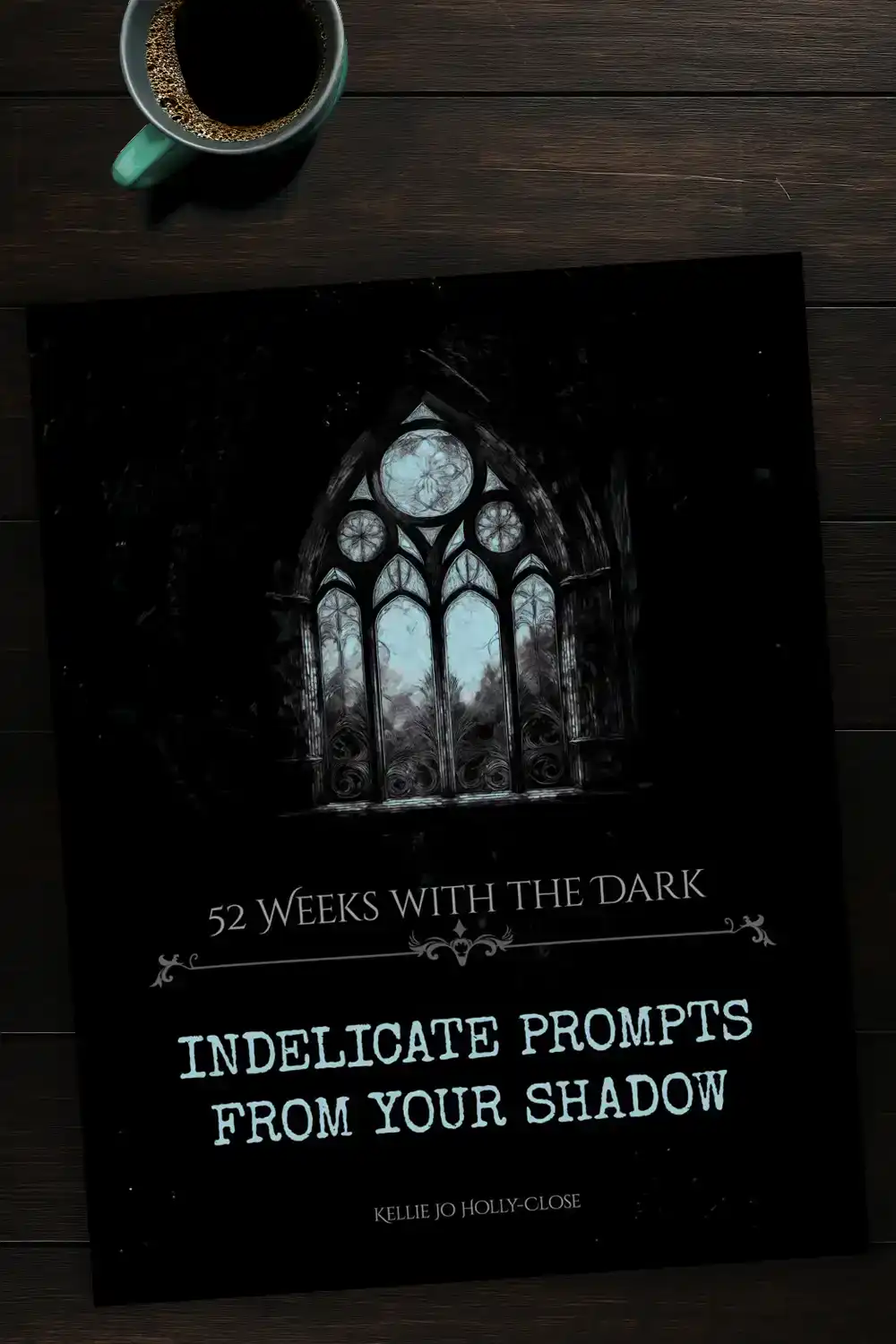 Cover of “52 Weeks with the Dark: Indelicate Prompts from Your Shadow” featuring a gothic window looking out onto a stark blue sky, evoking introspection, isolation, and inner reckoning.