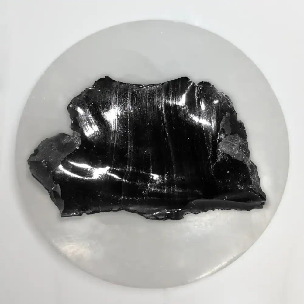 one polished, wavy black rock called obsidian with some sharp looking edges.