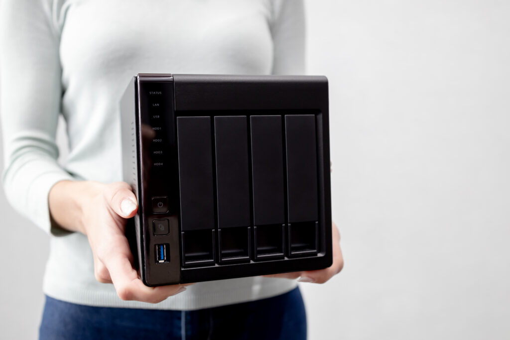 female holds small nas backup server data backup security concept