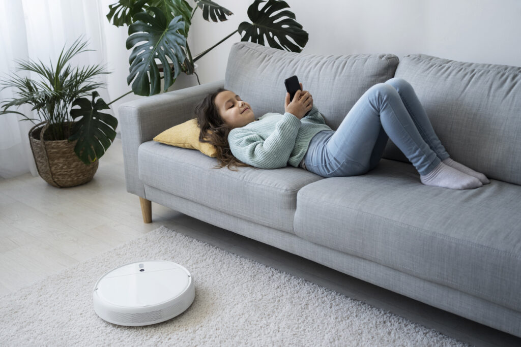 full shot girl laying couch with smartphone