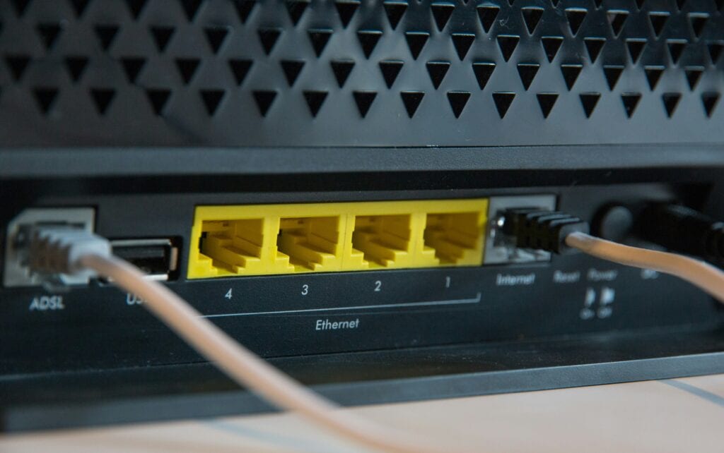Ethernet router ports with connected network cables; close-up of network hardware.